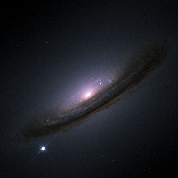 The supernova SN 1994D (the bright white dot in the bottom left of the image), in the spiral galaxy NGC4526.